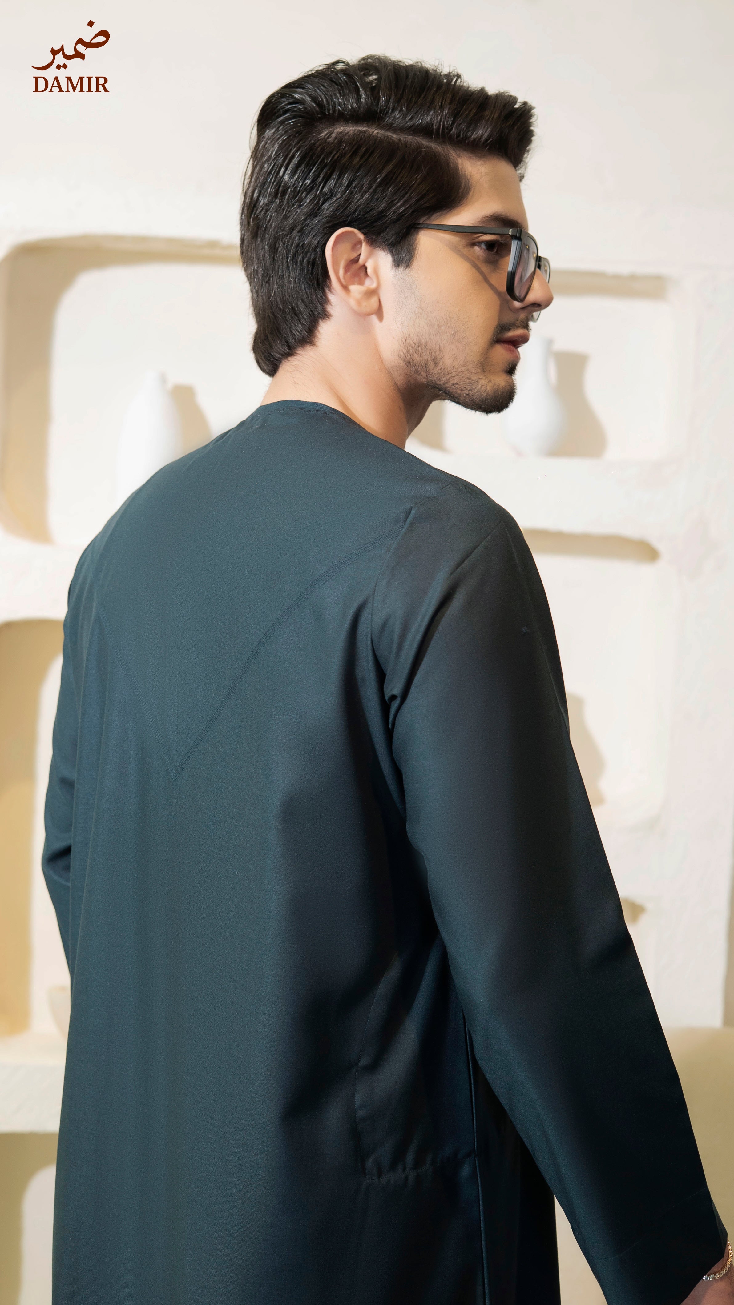 Man wearing a Teal outfit with a blurred background